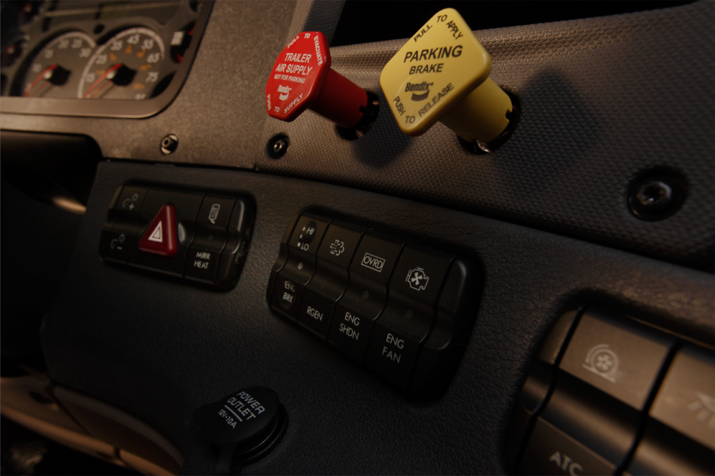 close up of semi trailer dash including parking break and trailer supply buttons
